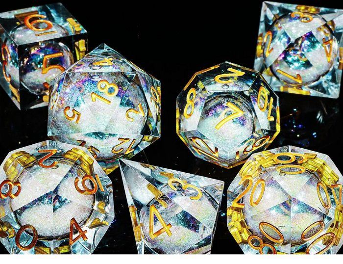 Image of set clear resin dnd dice with liquid core of white glitter featuring gold numbers