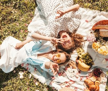 couple having a picnic and thinking of their 2023 love horoscope