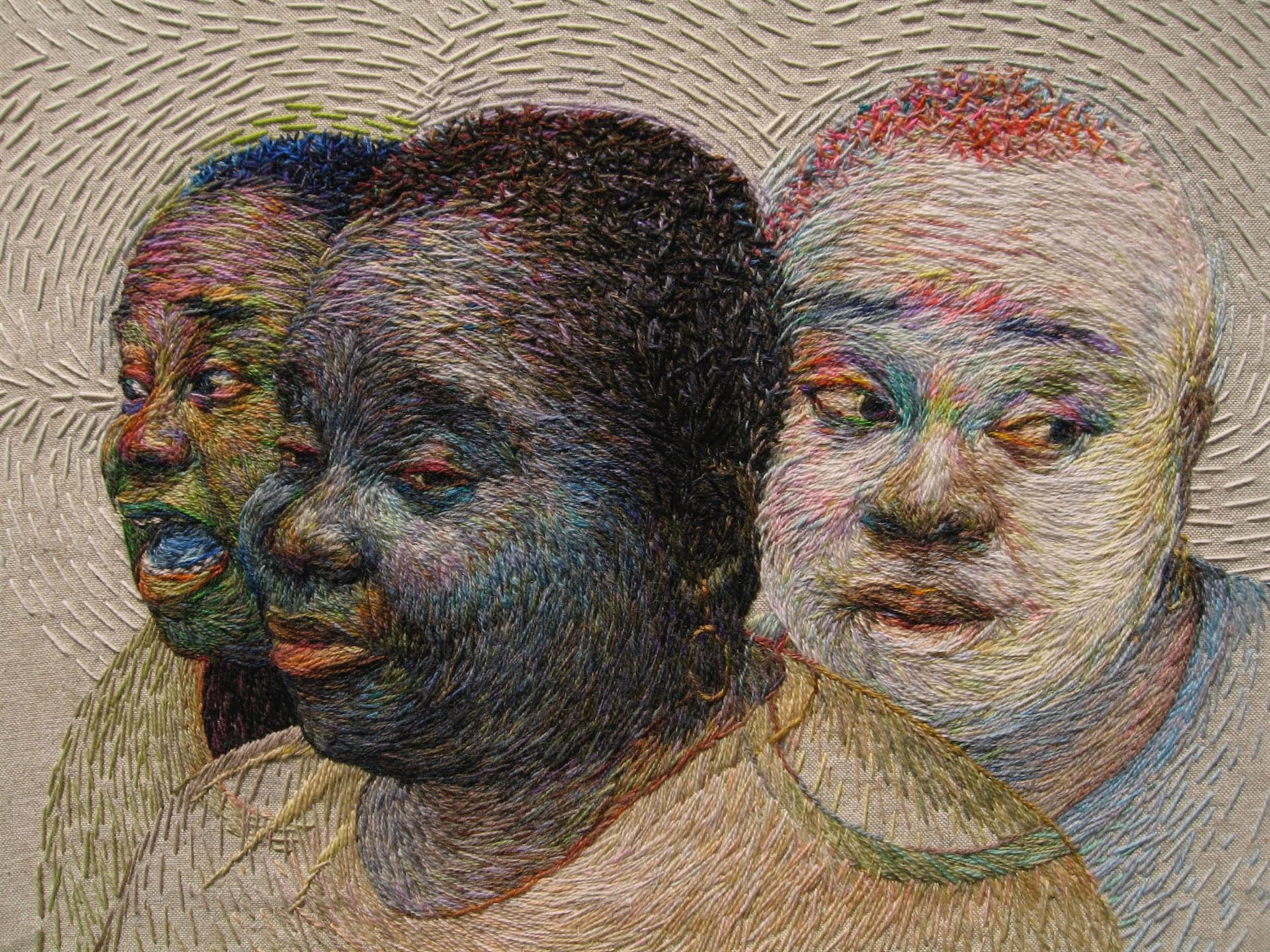 An embroidered portrait of three people