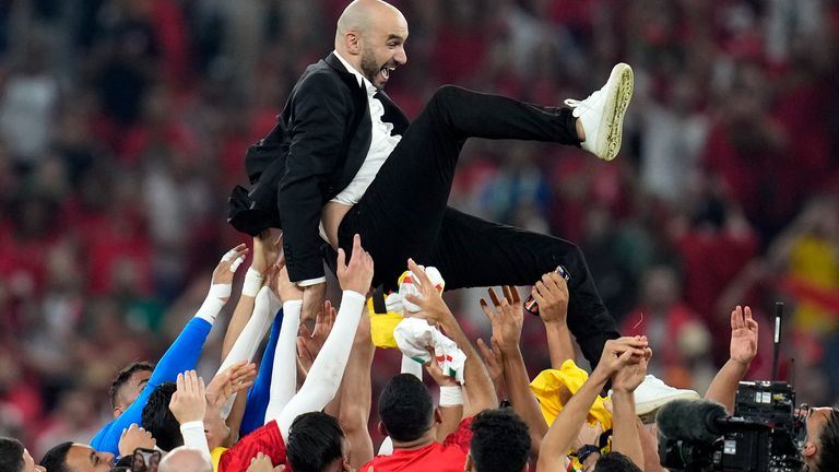 Morocco&#39;s head coach Walid Regragui is thrown in the air by his players after winning the World Cup group F soccer match between Canada and Morocco at the Al Thumama Stadium in Doha , Qatar, Thursday, Dec. 1, 2022. (AP Photo/Natacha Pisarenko)