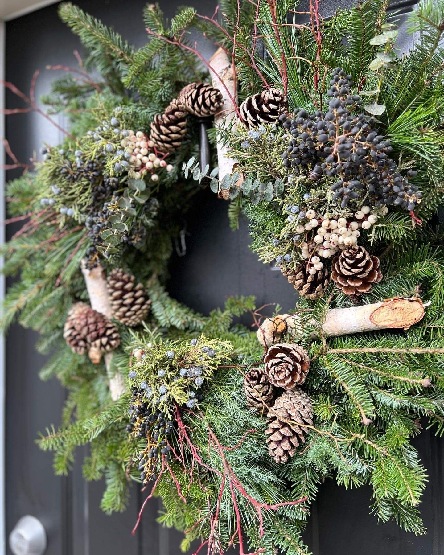 wreath with various branches and pinecones