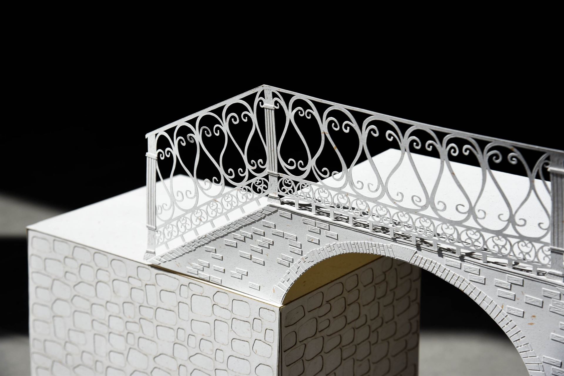 A detail of an architectural sculpture made of paper.