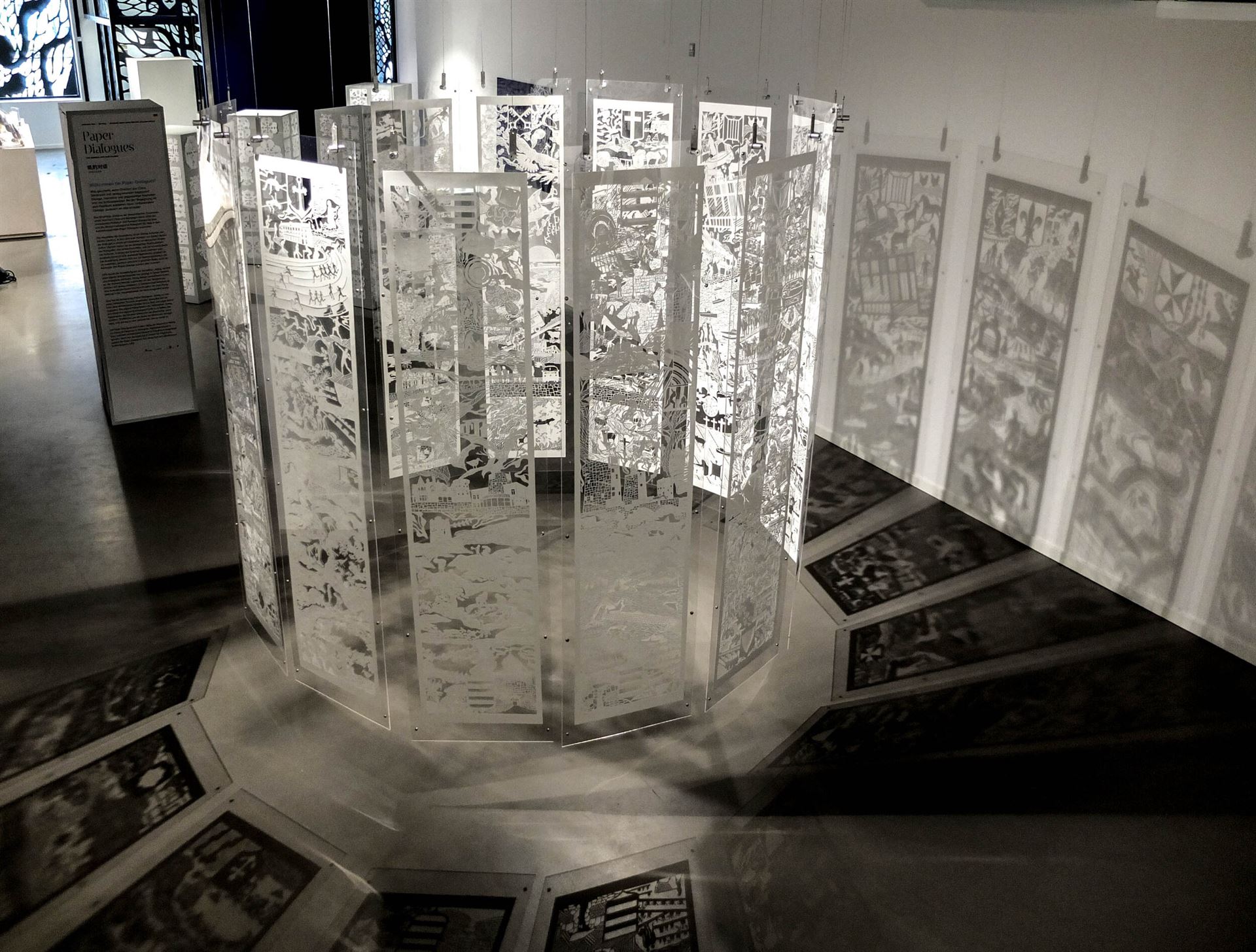 An installation view of a large-scale papercut artwork featuring a narrative of Jersey.