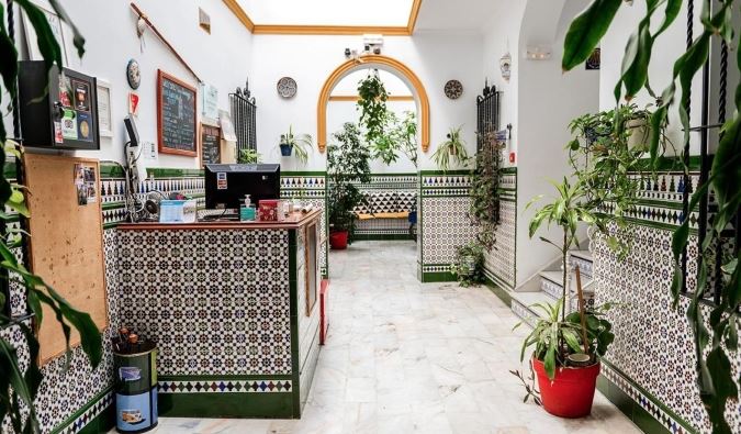 The traditionally tiled reception area and lobby of Triana Hostel in Sevilla, Spain